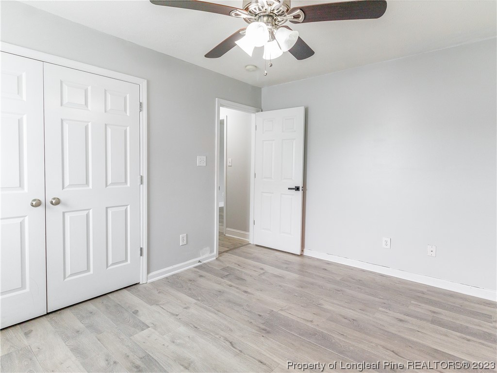 1964 Yellowbrick Road Fayetteville, NC 28314 - Photo 24 of 37 an empty room with wooden floor fan and windows
