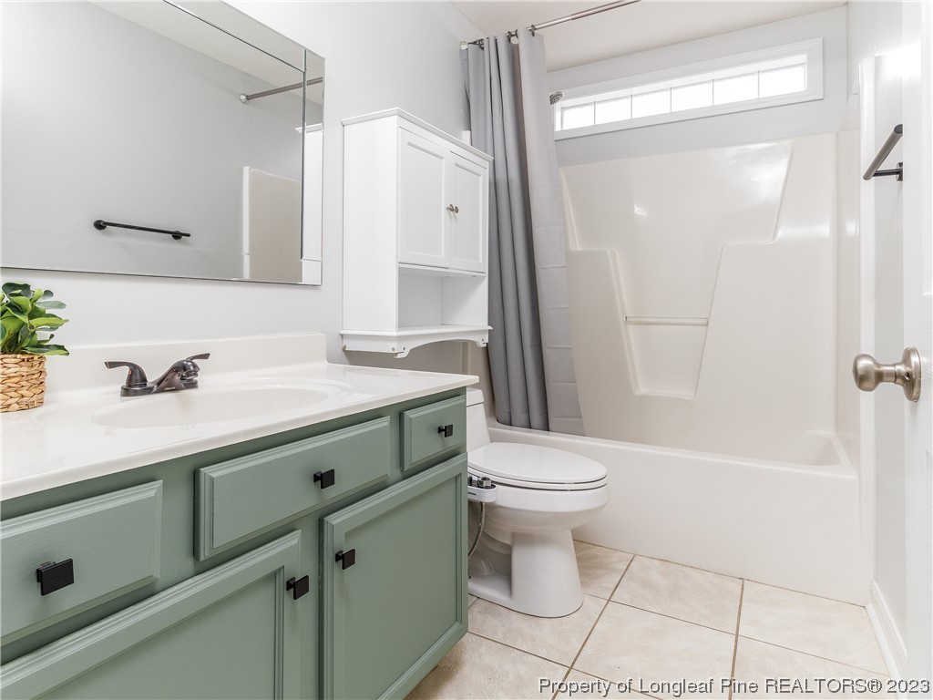 1964 Yellowbrick Road Fayetteville, NC 28314 - Photo 27 of 37 a bathroom with a sink a toilet and shower