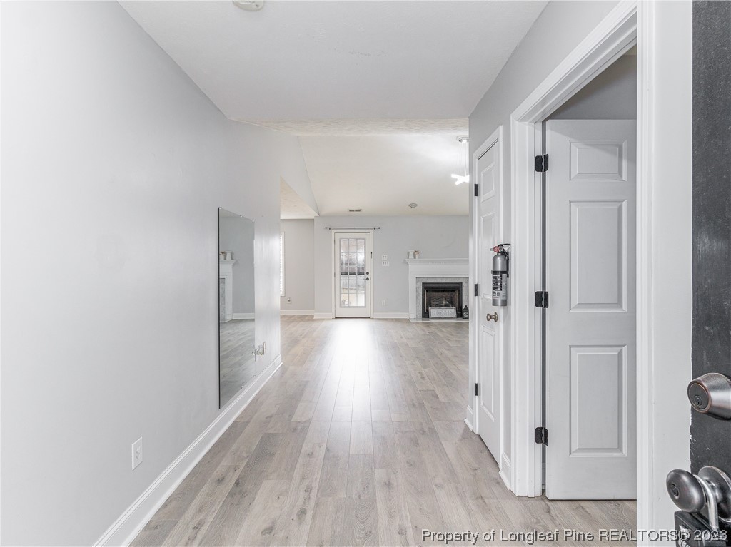 1964 Yellowbrick Road Fayetteville, NC 28314 - Photo 6 of 37 a view of a hallway with wooden floor