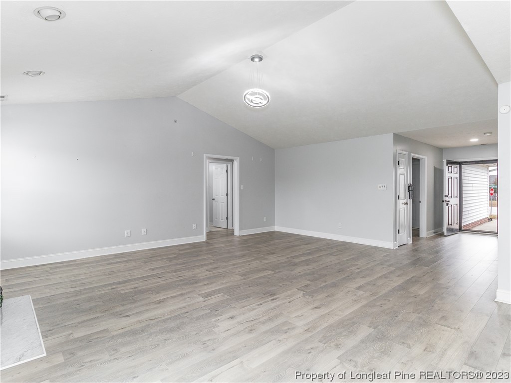 1964 Yellowbrick Road Fayetteville, NC 28314 - Photo 7 of 37 a view of an empty room with wooden floor and a window