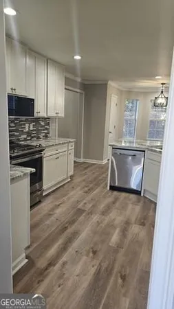a kitchen with stainless steel appliances granite countertop a stove and a sink