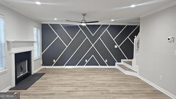a view of room with wooden floor and fireplace