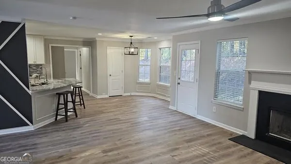 a view of a livingroom with furniture hardwood floor and a ceiling fan