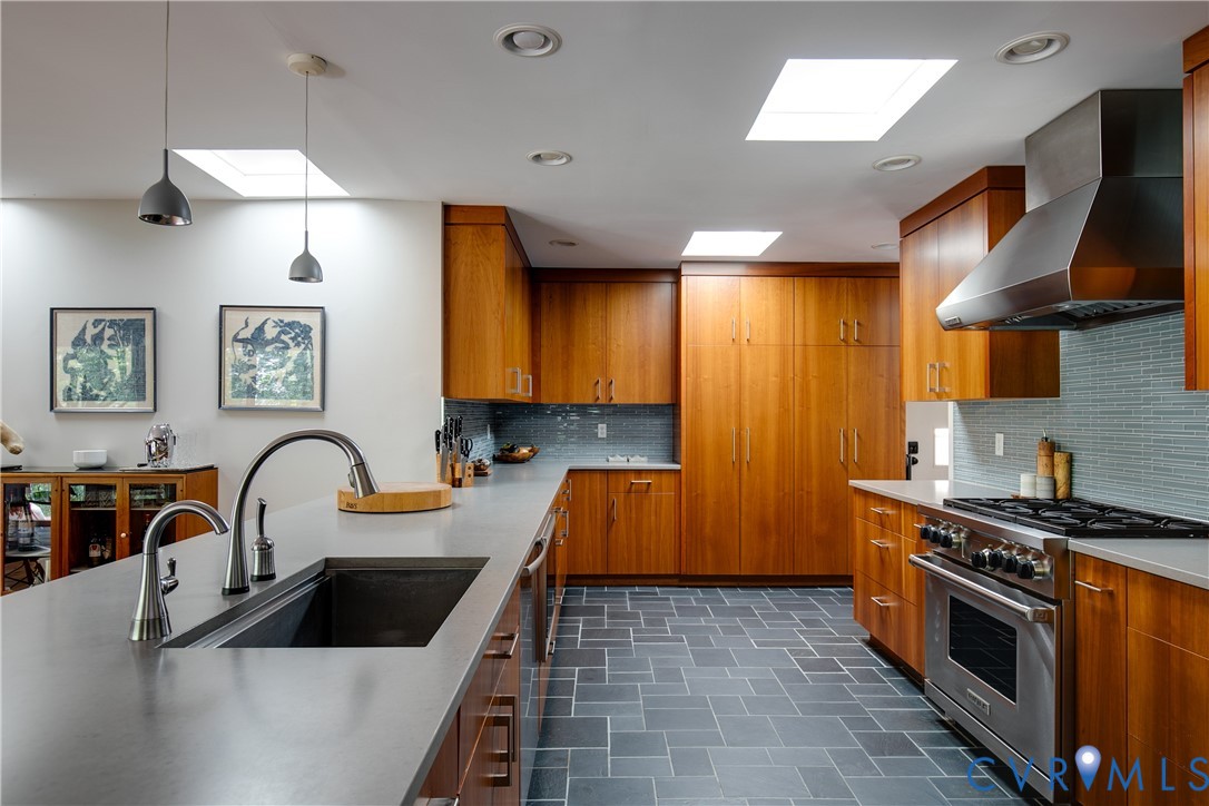 380 Flag Station Road Henrico, VA 23238 - Photo 18 of 70 a kitchen with granite countertop a stove a sink and a microwave