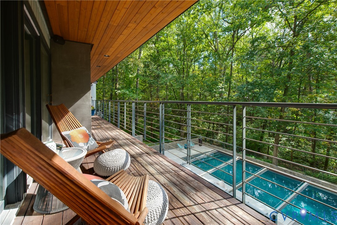 380 Flag Station Road Henrico, VA 23238 - Photo 24 of 70 a balcony with wooden floor table and chairs