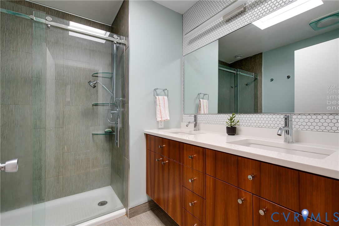 380 Flag Station Road Henrico, VA 23238 - Photo 41 of 70 a bathroom with a double vanity sink mirror double shower and a bathtub