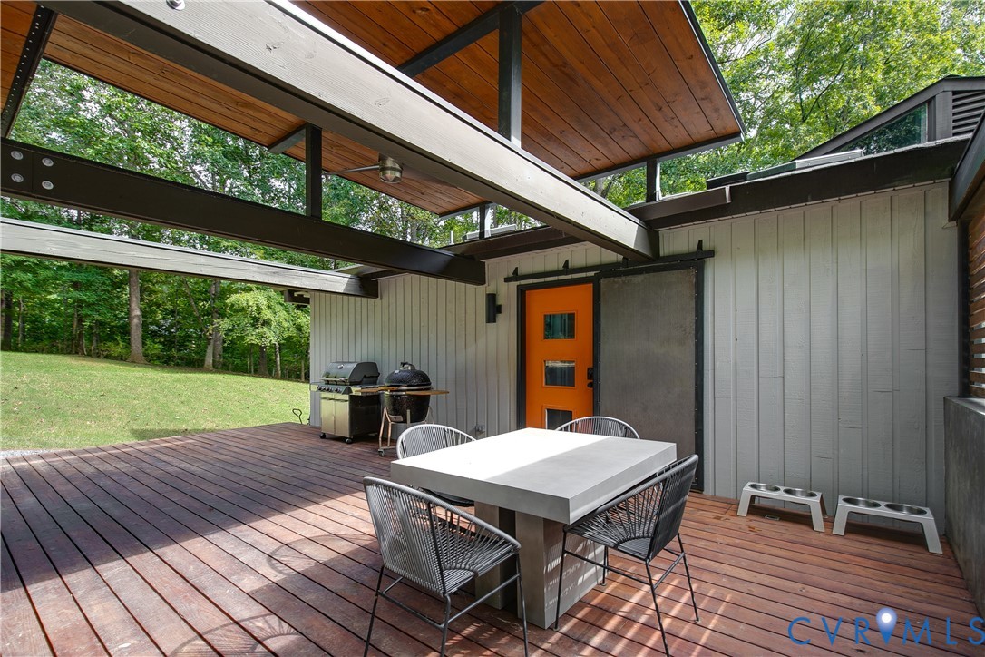 380 Flag Station Road Henrico, VA 23238 - Photo 45 of 70 a view of a patio with table and chairs under an umbrella with a small yard
