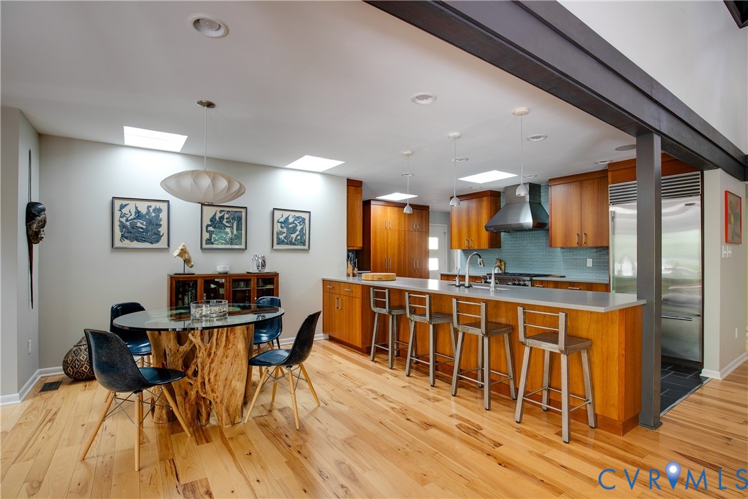 380 Flag Station Road Henrico, VA 23238 - Photo 8 of 70 a kitchen with stainless steel appliances kitchen island granite countertop a table chairs sink and cabinets