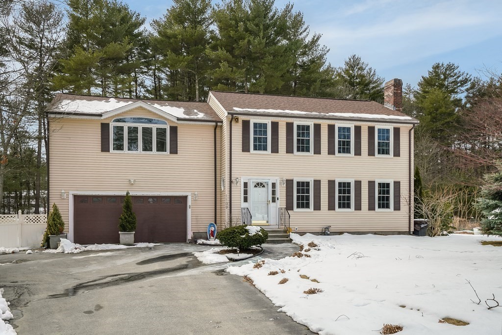 1109 Whipple Road Tewksbury, MA 01876 - Photo 1 of 25 a front view of a house with a yard