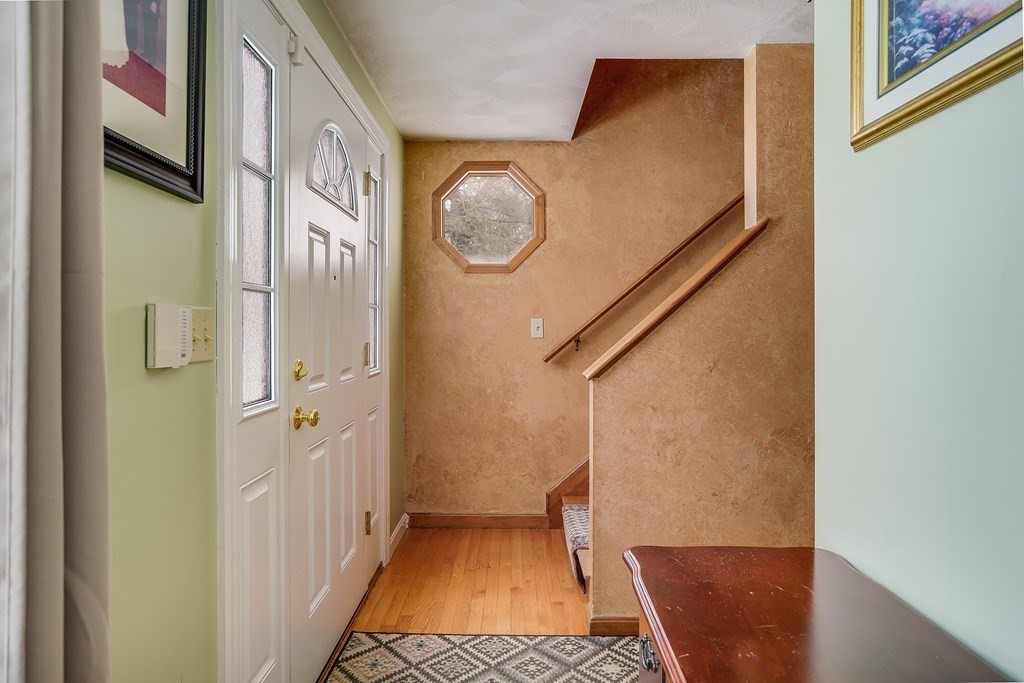 1109 Whipple Road Tewksbury, MA 01876 - Photo 11 of 25 a view of a hallway with entryway wooden floor and door