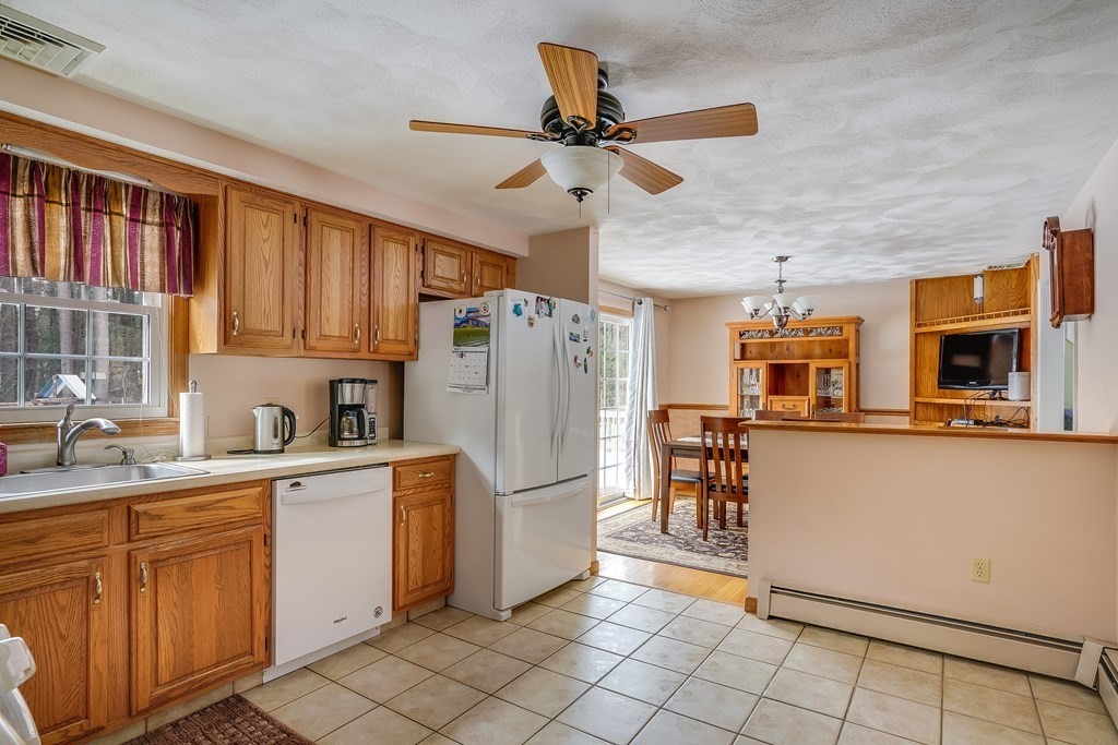 1109 Whipple Road Tewksbury, MA 01876 - Photo 15 of 25 a kitchen with stainless steel appliances a refrigerator sink and cabinets