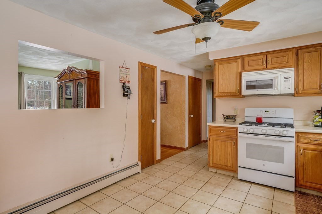 1109 Whipple Road Tewksbury, MA 01876 - Photo 17 of 25 a kitchen with granite countertop cabinets and window