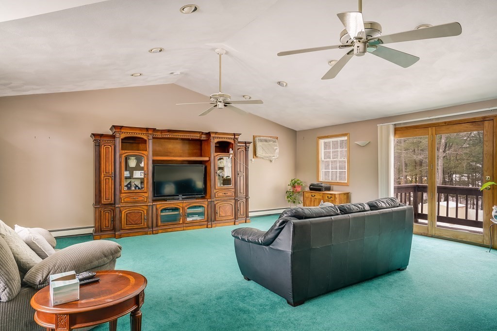 1109 Whipple Road Tewksbury, MA 01876 - Photo 2 of 25 a living room with furniture and a flat screen tv