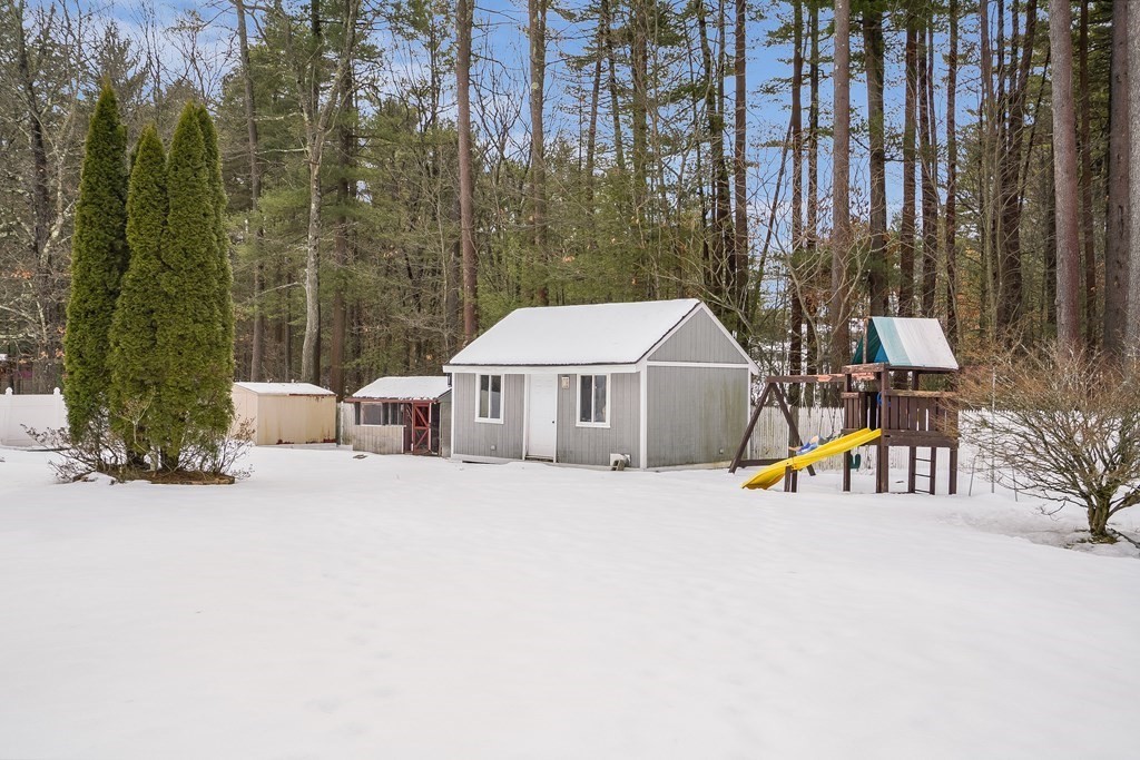 1109 Whipple Road Tewksbury, MA 01876 - Photo 21 of 25 a view of a white house with a yard and sitting area