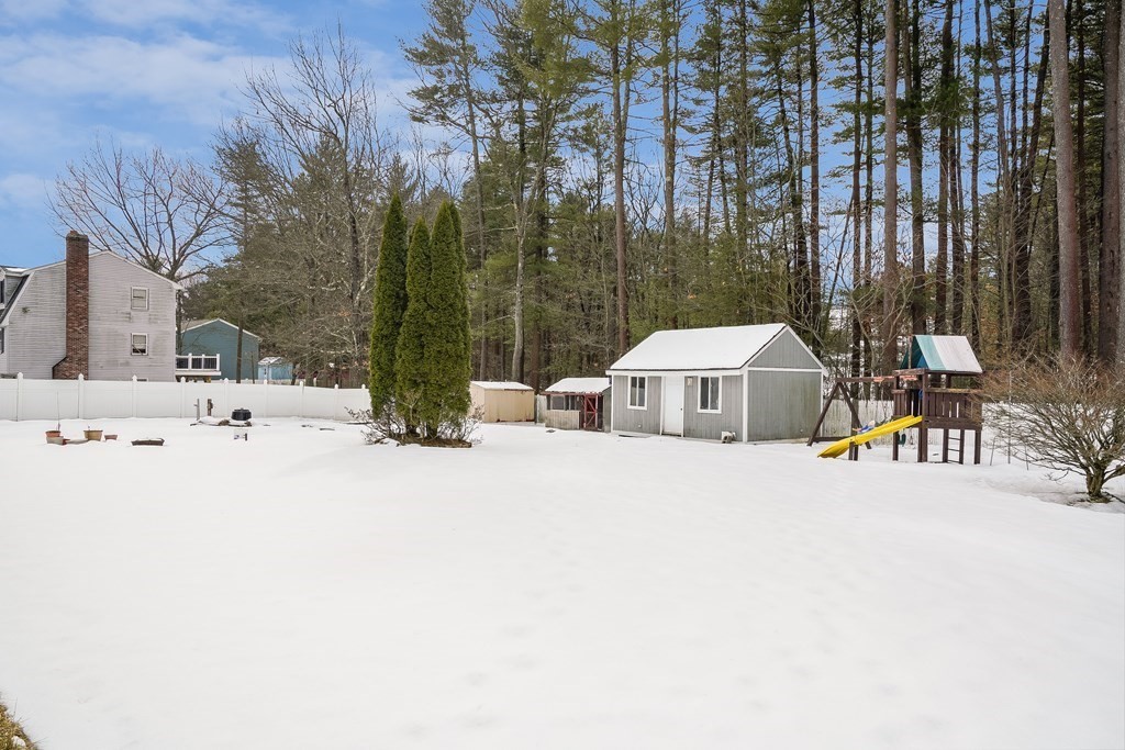 1109 Whipple Road Tewksbury, MA 01876 - Photo 22 of 25 a view of a house with snow on the road