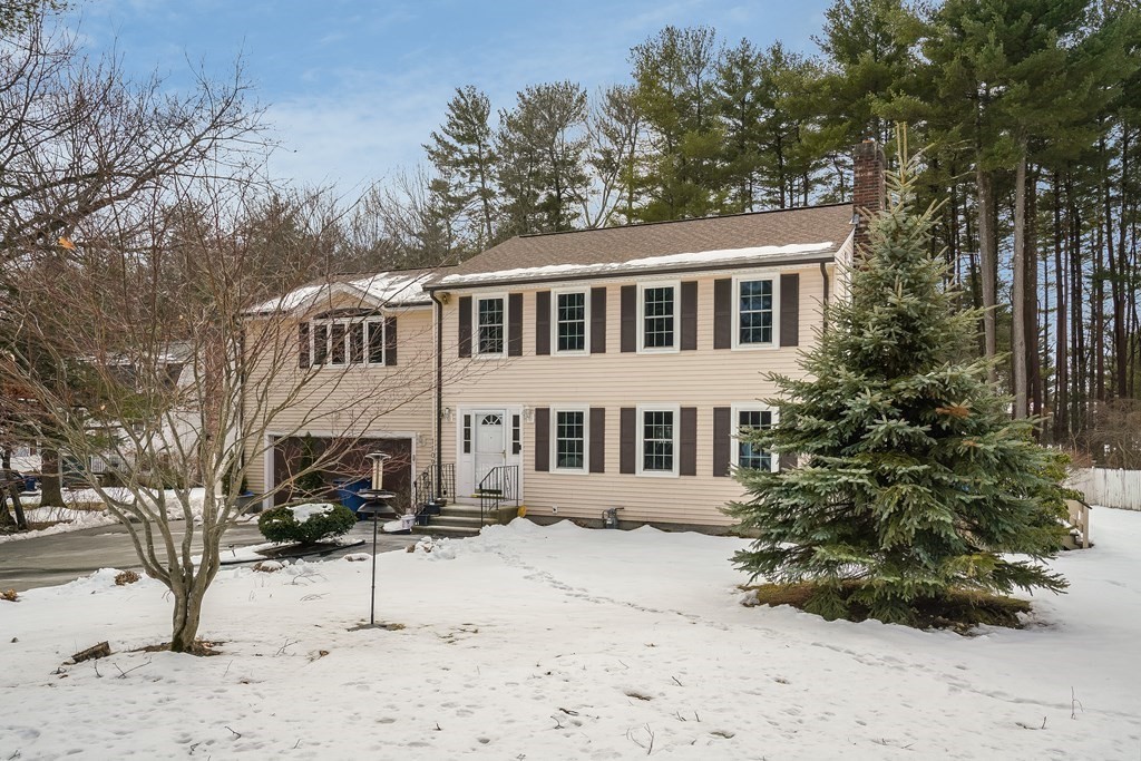 1109 Whipple Road Tewksbury, MA 01876 - Photo 24 of 25 a front view of a house with a yard covered in snow