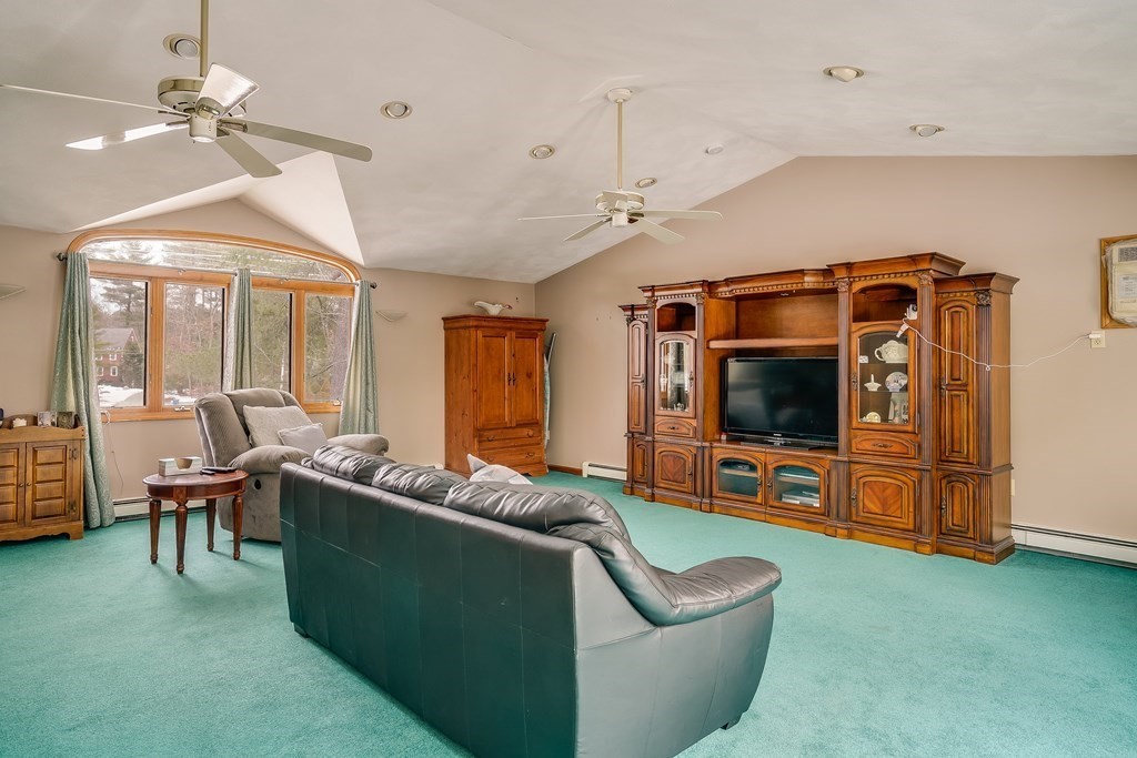 1109 Whipple Road Tewksbury, MA 01876 - Photo 3 of 25 a living room with furniture and a flat screen tv
