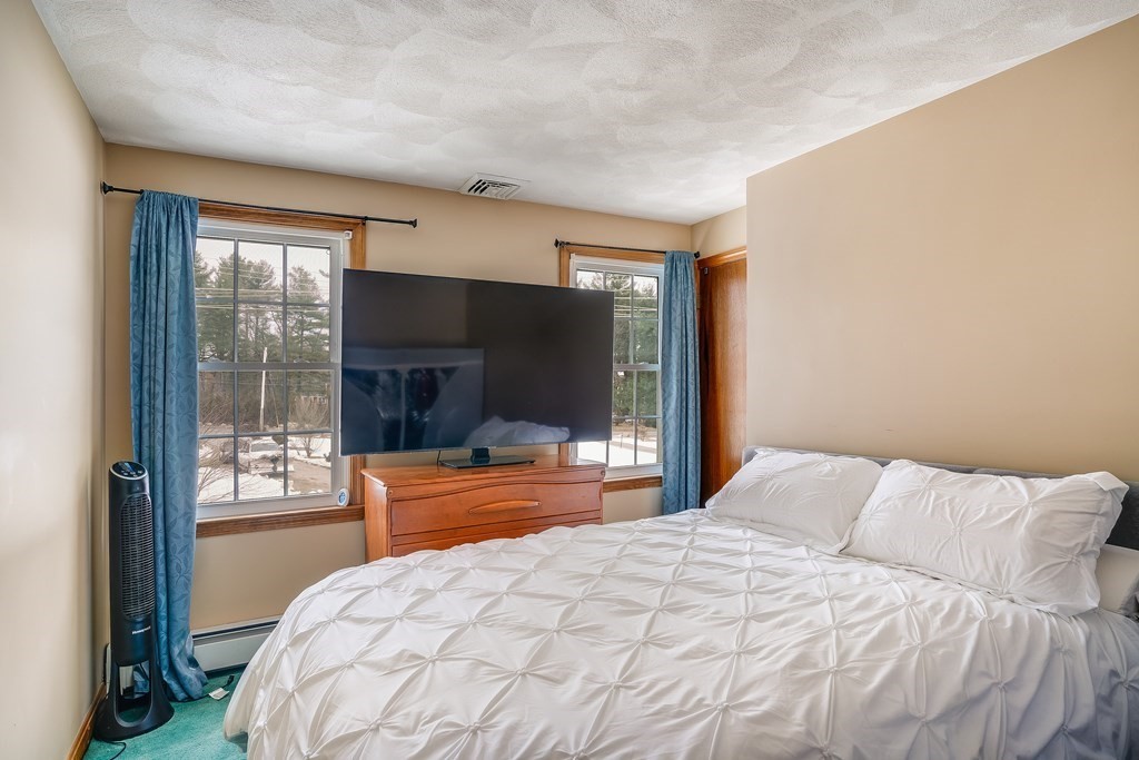 1109 Whipple Road Tewksbury, MA 01876 - Photo 6 of 25 a bedroom with a large bed and a large window