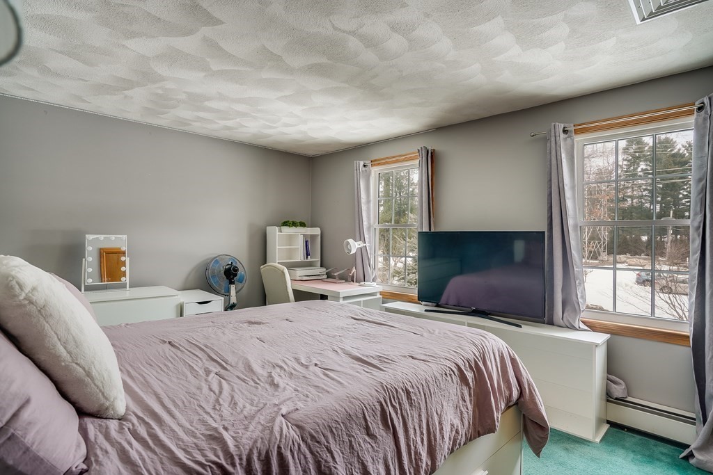 1109 Whipple Road Tewksbury, MA 01876 - Photo 7 of 25 a bedroom with a large bed and a window