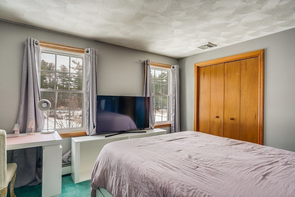 1109 Whipple Road Tewksbury, MA 01876 - Photo 8 of 25 a bedroom with a large bed and a large window