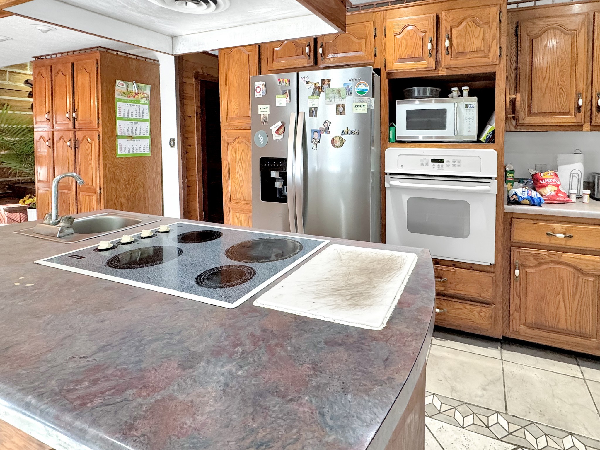 480 Hickman Shores Road Dover, TN 37058 - Photo 13 of 44 a kitchen with stainless steel appliances granite countertop a refrigerator a oven and white cabinets with wooden floors
