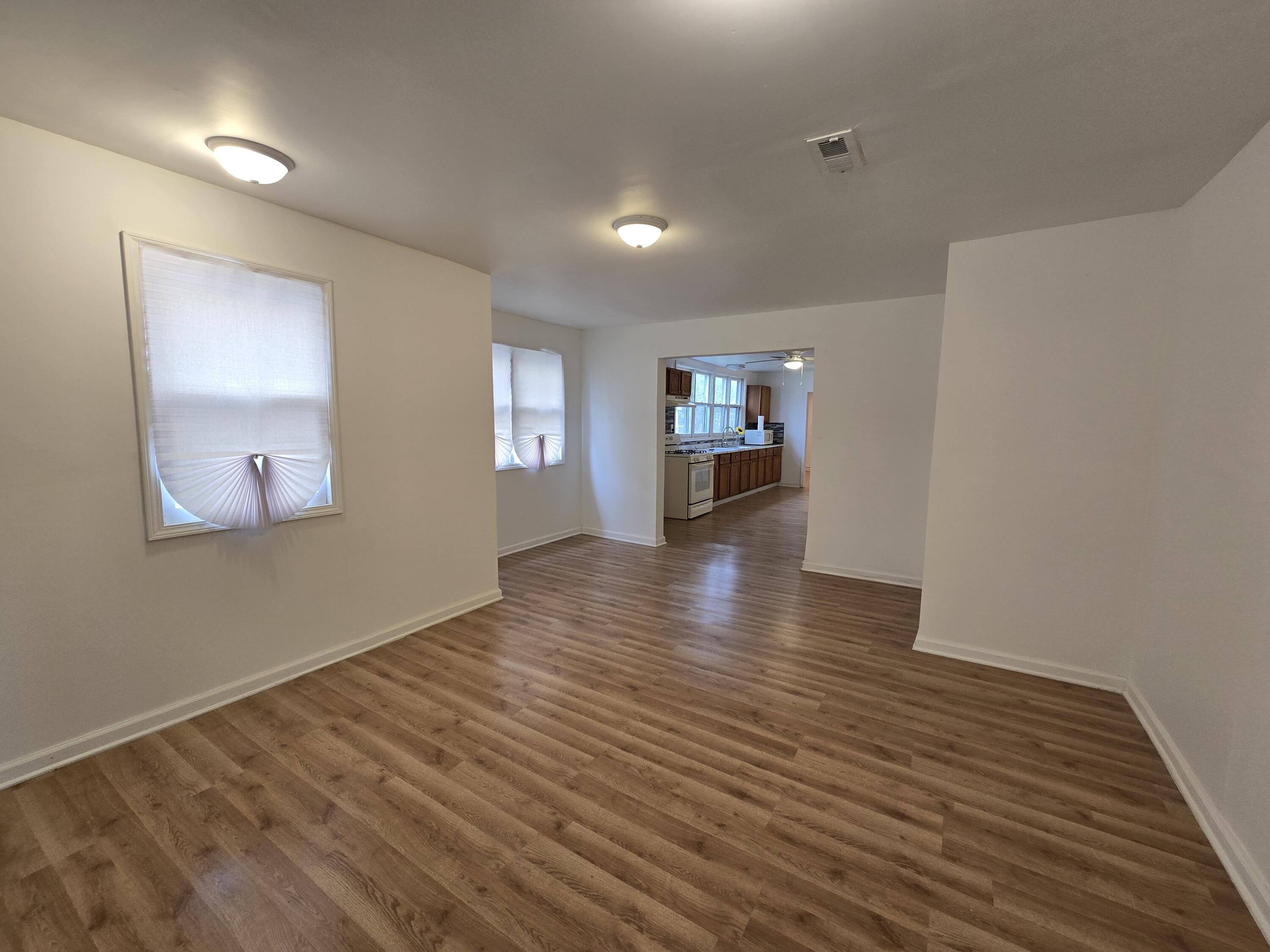 2128 Tennessee Street Gary, IN 46407 - Photo 13 of 26 a view of an empty room with window and wooden floor