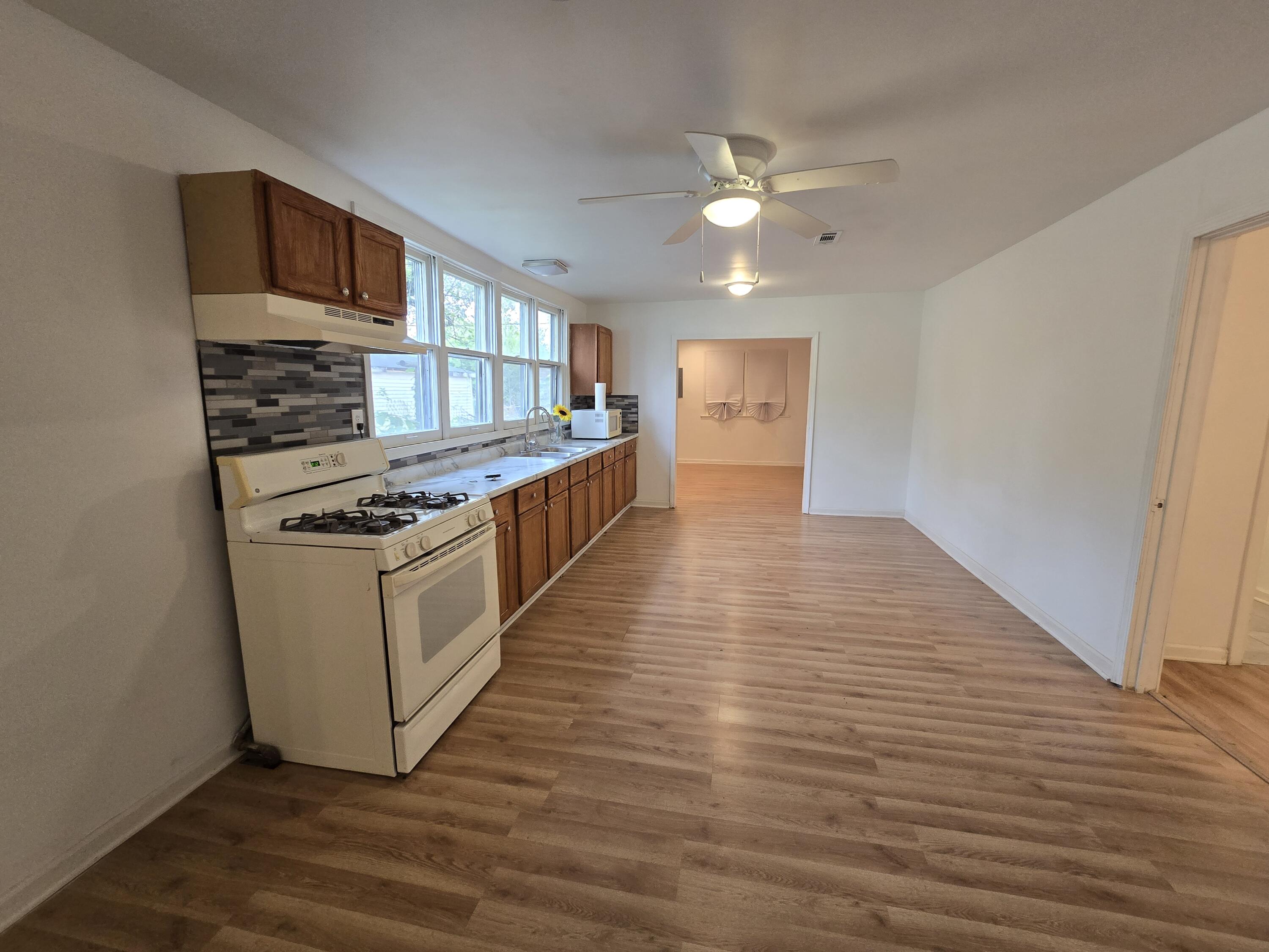2128 Tennessee Street Gary, IN 46407 - Photo 14 of 26 a kitchen with stainless steel appliances a stove top oven and cabinets