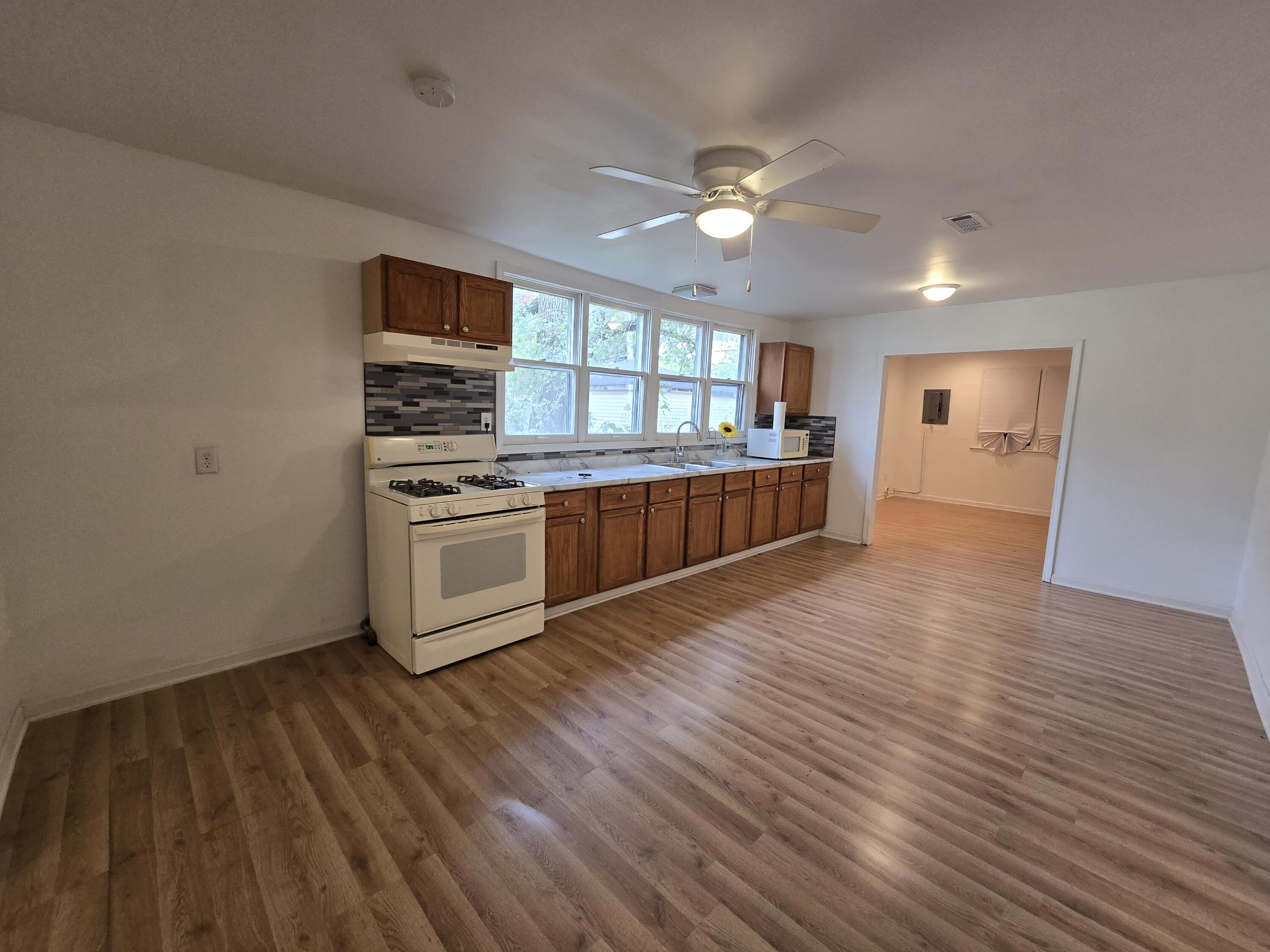 2128 Tennessee Street Gary, IN 46407 - Photo 15 of 26 a kitchen with stainless steel appliances granite countertop a sink cabinets and wooden floor