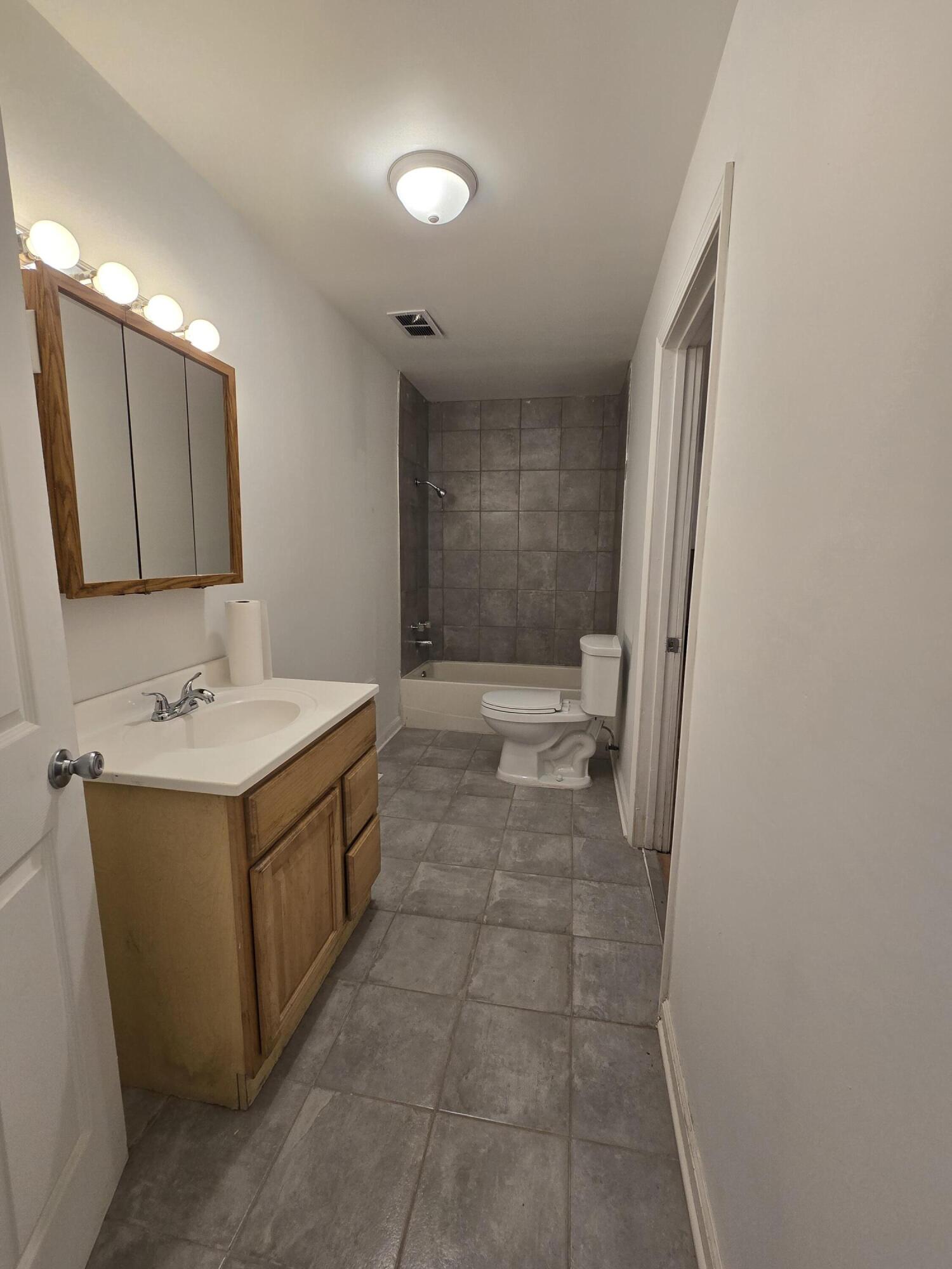 2128 Tennessee Street Gary, IN 46407 - Photo 21 of 26 a bathroom with a sink a toilet and mirror