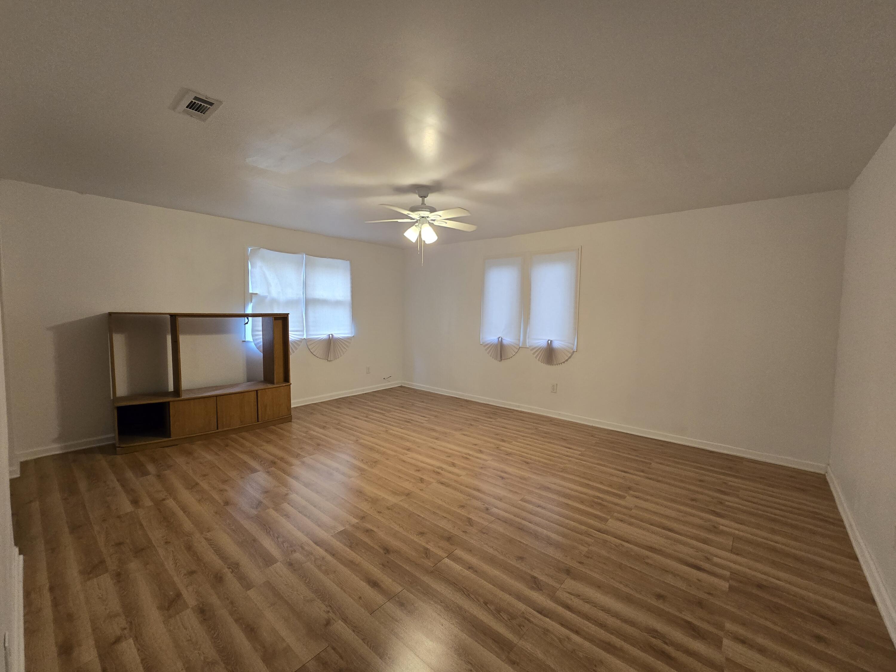 2128 Tennessee Street Gary, IN 46407 - Photo 22 of 26 a view of an empty room with window and wooden floor