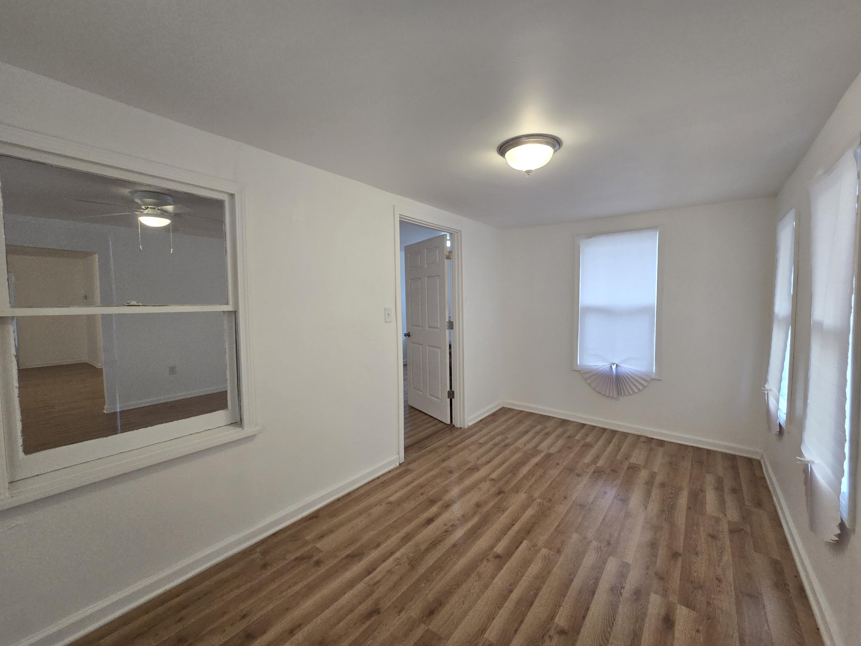2128 Tennessee Street Gary, IN 46407 - Photo 4 of 26 a view of empty room with wooden floor and fan