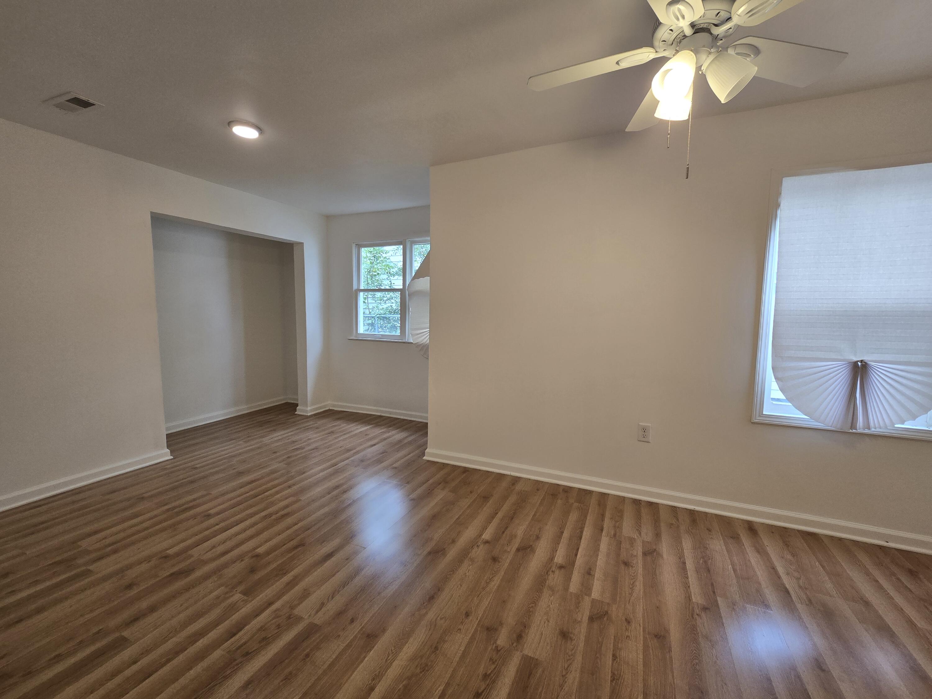 2128 Tennessee Street Gary, IN 46407 - Photo 10 of 26 an empty room with wooden floor and windows