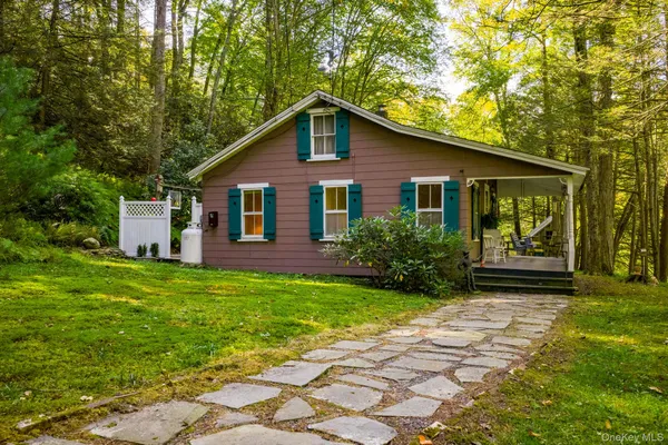 a view of backyard of house with green space