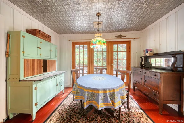 a dining room with furniture and a window