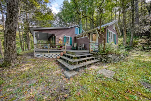 a yellow building with trees in front of it