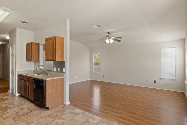 an open kitchen with sink and cabinets