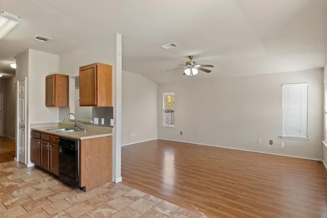 an open kitchen with sink and cabinets