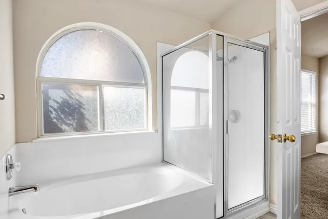 a bathroom with a bathtub and a shower