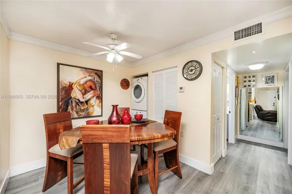 a view of a dining room with furniture and wooden floor