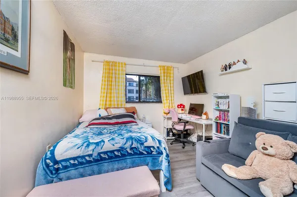 a bedroom with bed and a couch