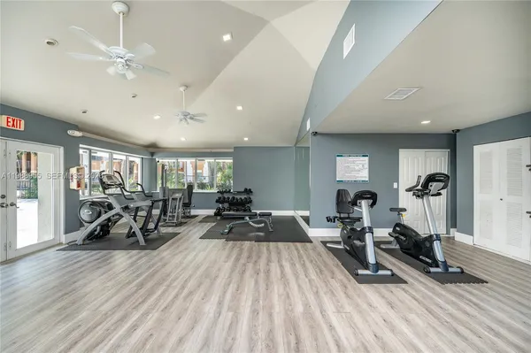 a view of a room with gym equipment and a large window