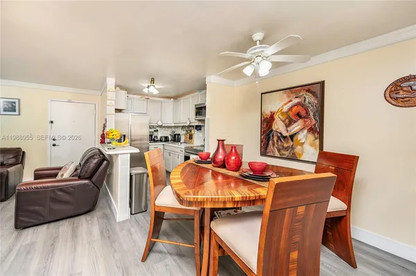 a living room with furniture and kitchen view