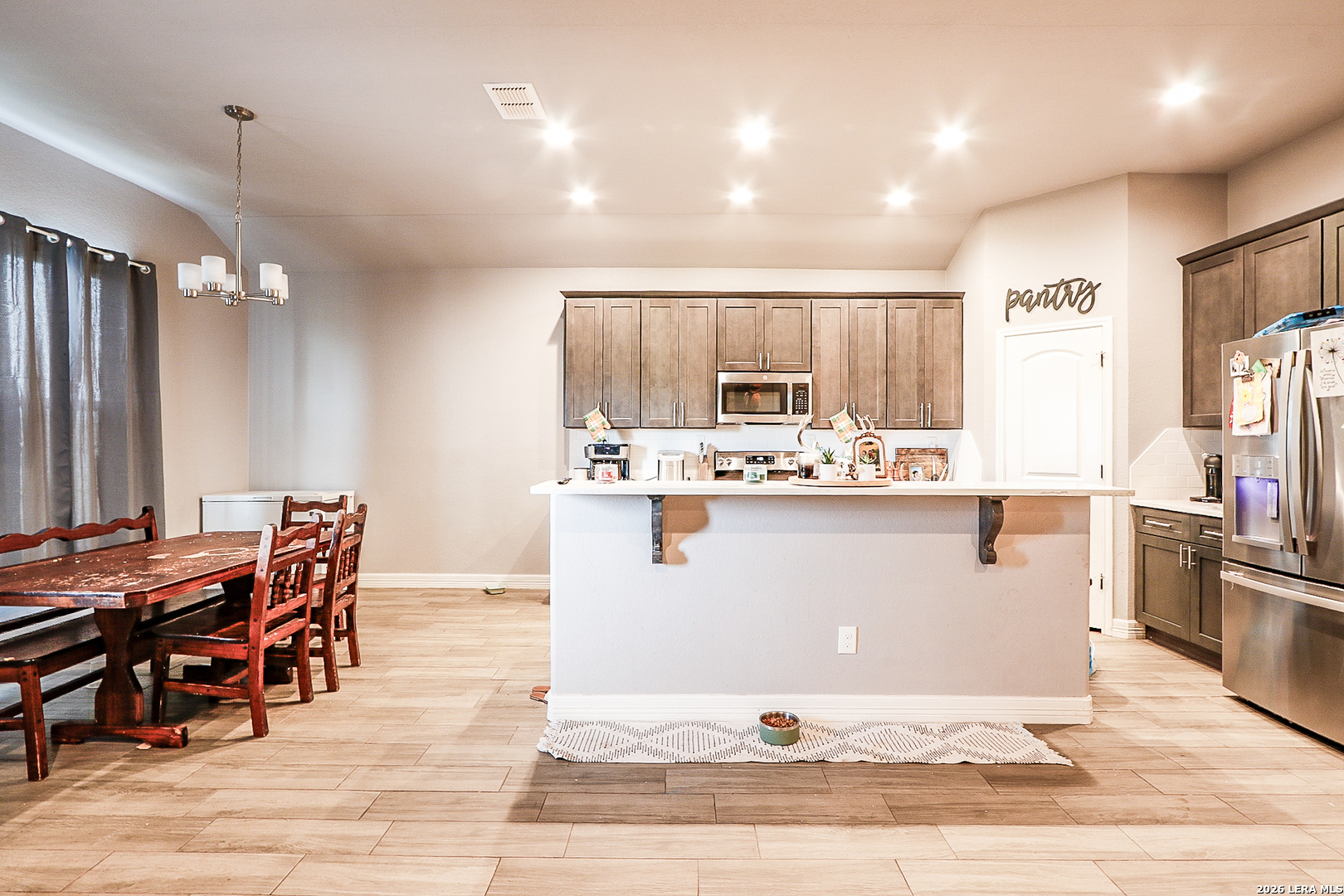281 Legend Hills Uvalde, TX 78801 - Photo 15 of 24 a kitchen with stainless steel appliances kitchen island granite countertop a table chairs sink and cabinets