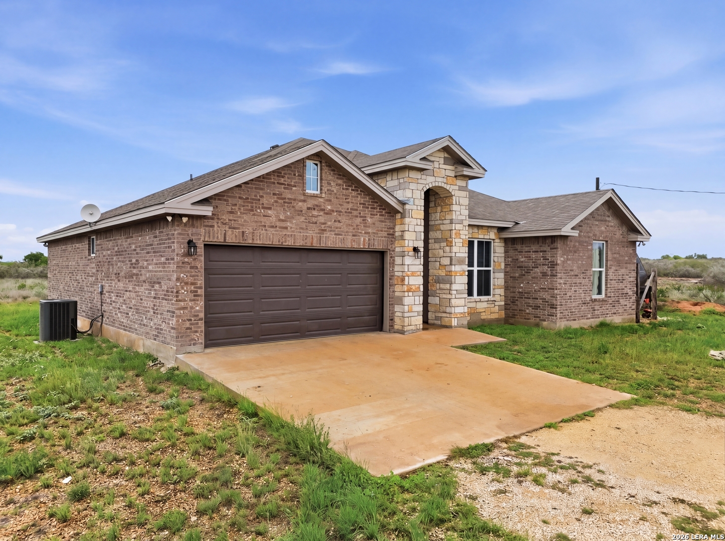 281 Legend Hills Uvalde, TX 78801 - Photo 5 of 24 a front view of a house with a yard and garage