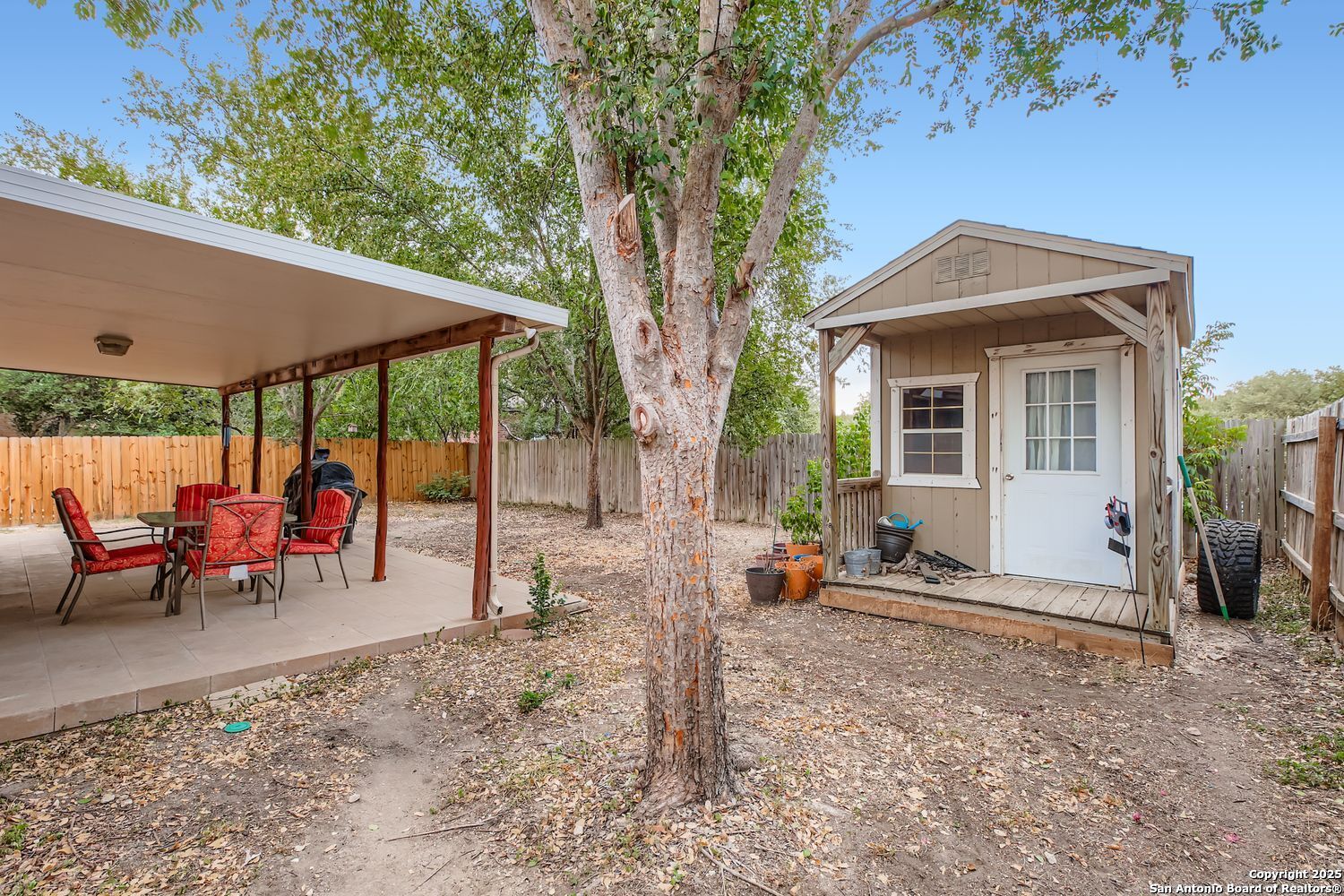 8614 Cross Spring San Antonio, TX 78251 - Photo 24 of 24 a view of a patio with a table chairs and a backyard