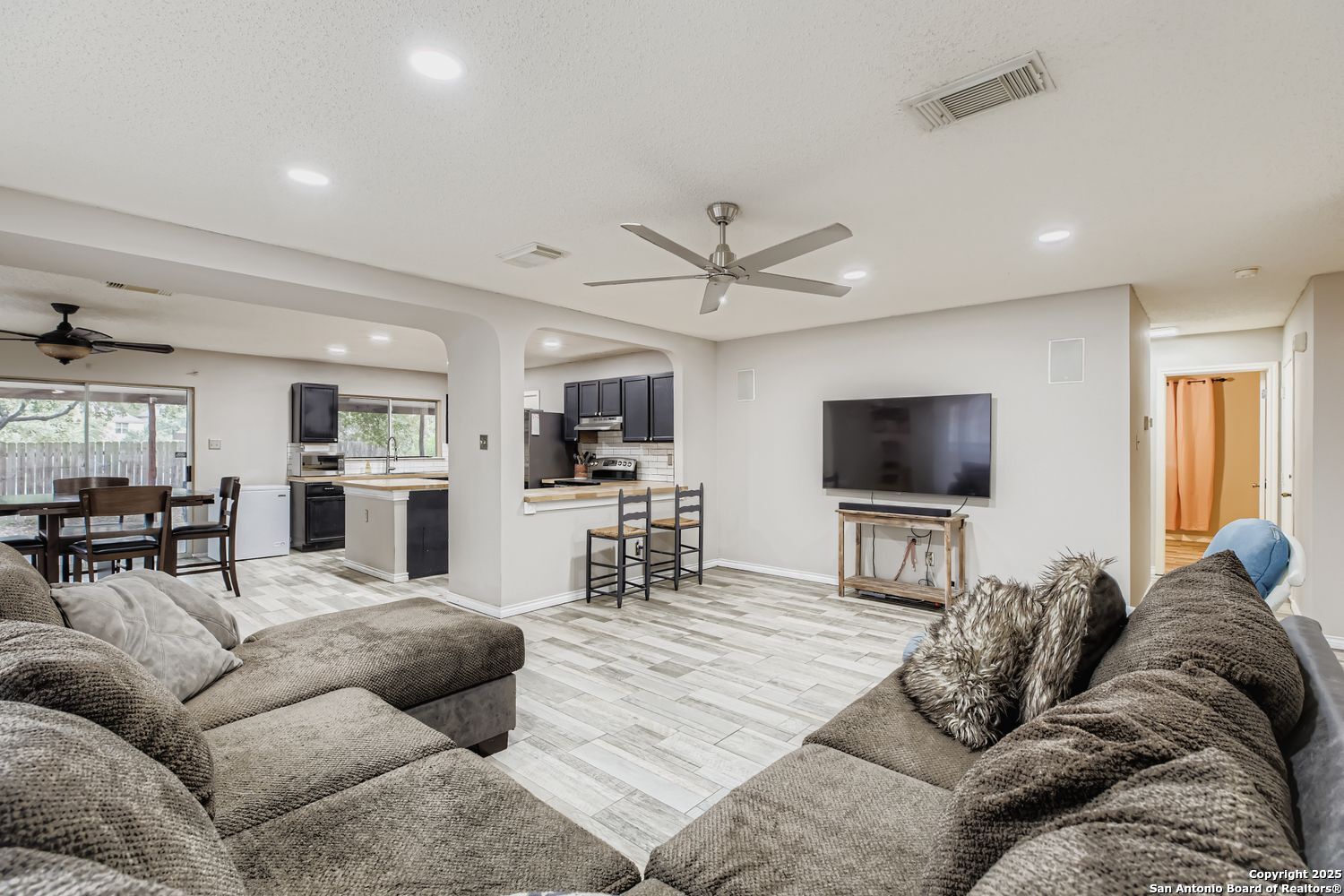 8614 Cross Spring San Antonio, TX 78251 - Photo 5 of 24 a living room with furniture kitchen view and a flat screen tv