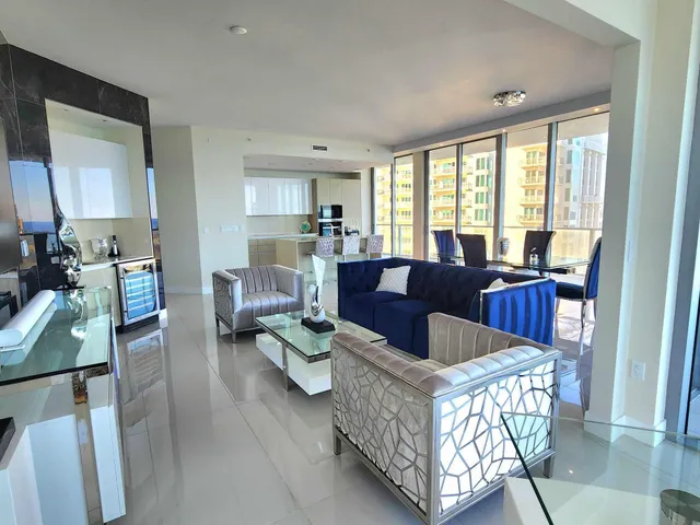 a living room with furniture and a large window