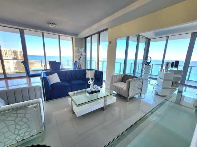 a view of living room with furniture and floor to ceiling window