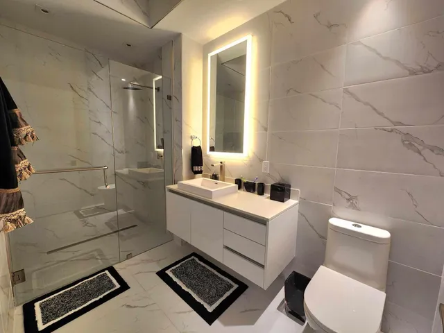 a bathroom with a sink toilet and shower