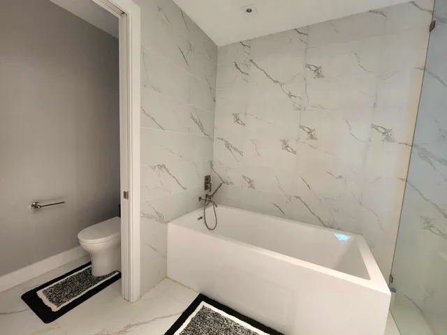 a bathroom with a bathtub and a shower